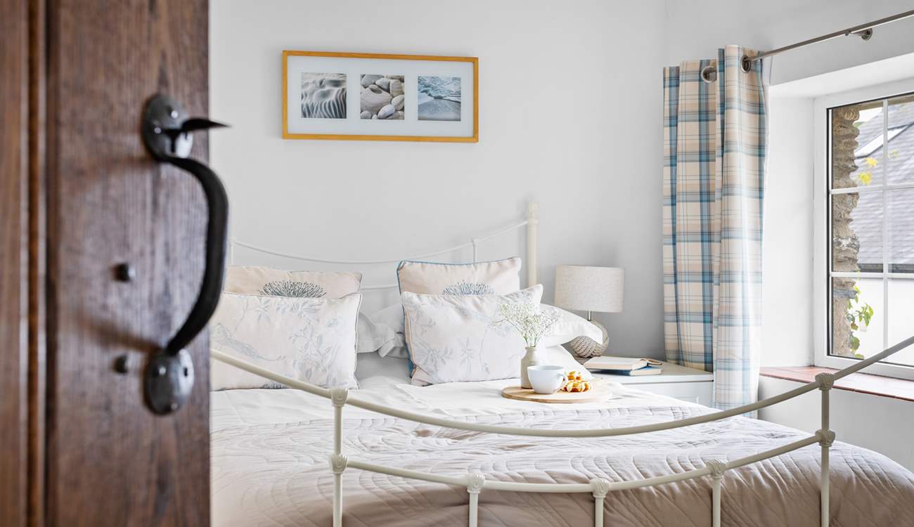 Light and airy bedroom 2 has a double bed.