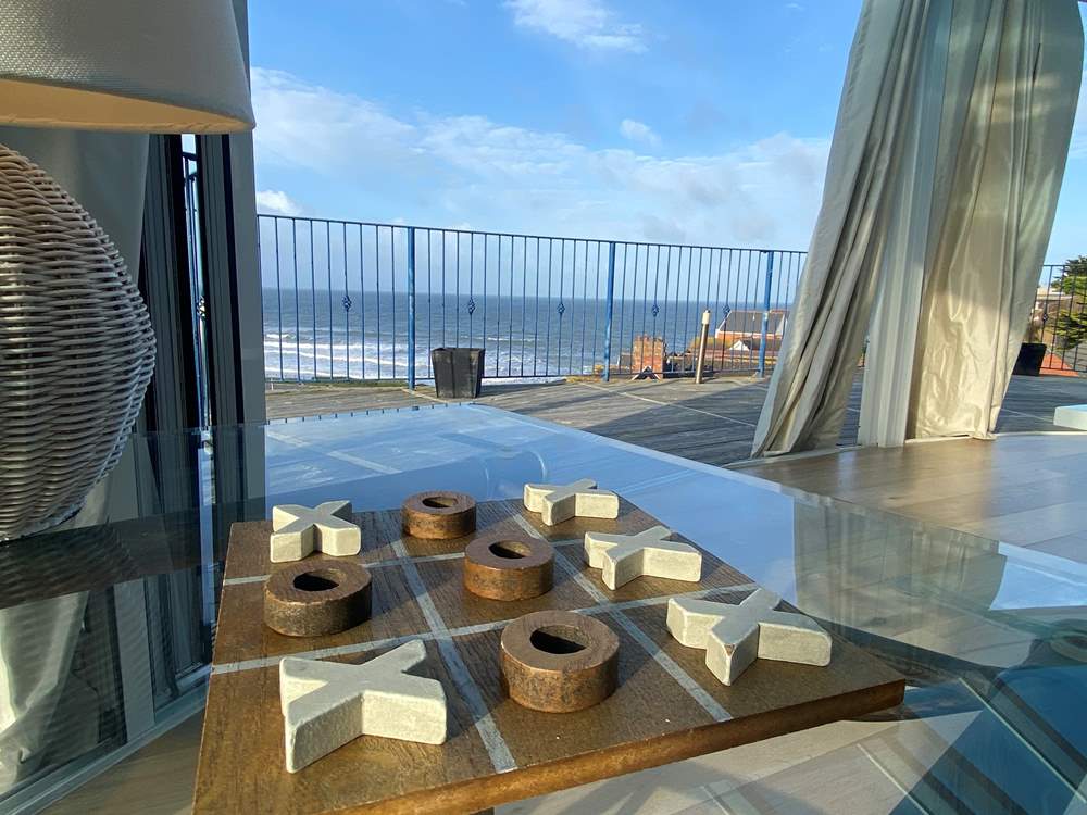 The living space opens out onto a wrap around balcony.