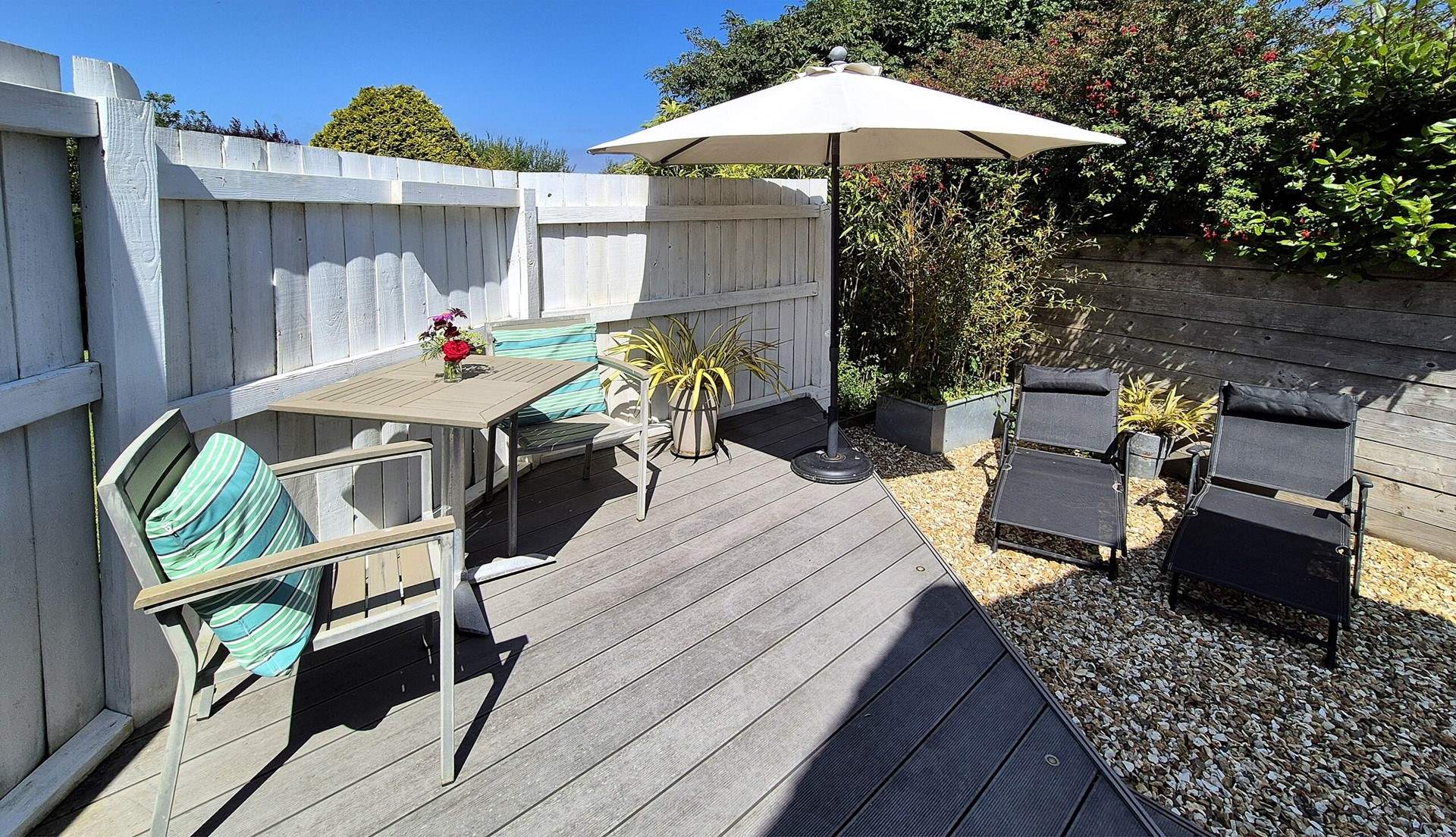 The terrace has a table and chairs for al fresco dining and sun-loungers. 