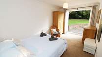 The double bedroom on the ground floor has doors leading out onto the patio.