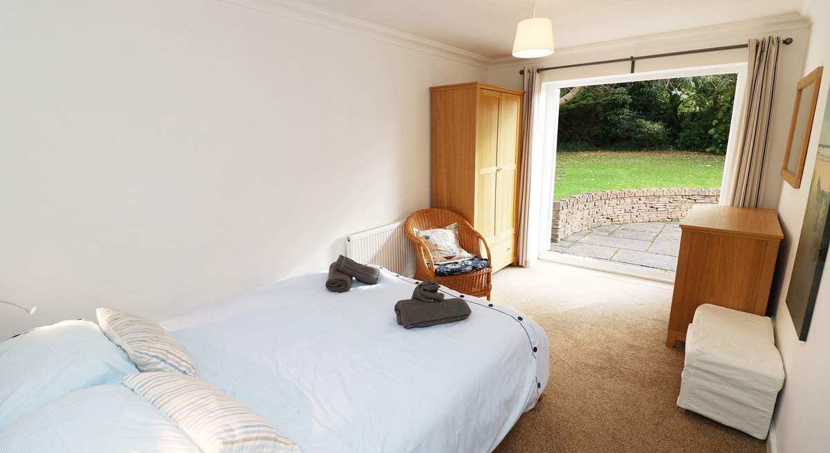 The double bedroom on the ground floor has doors leading out onto the patio.
