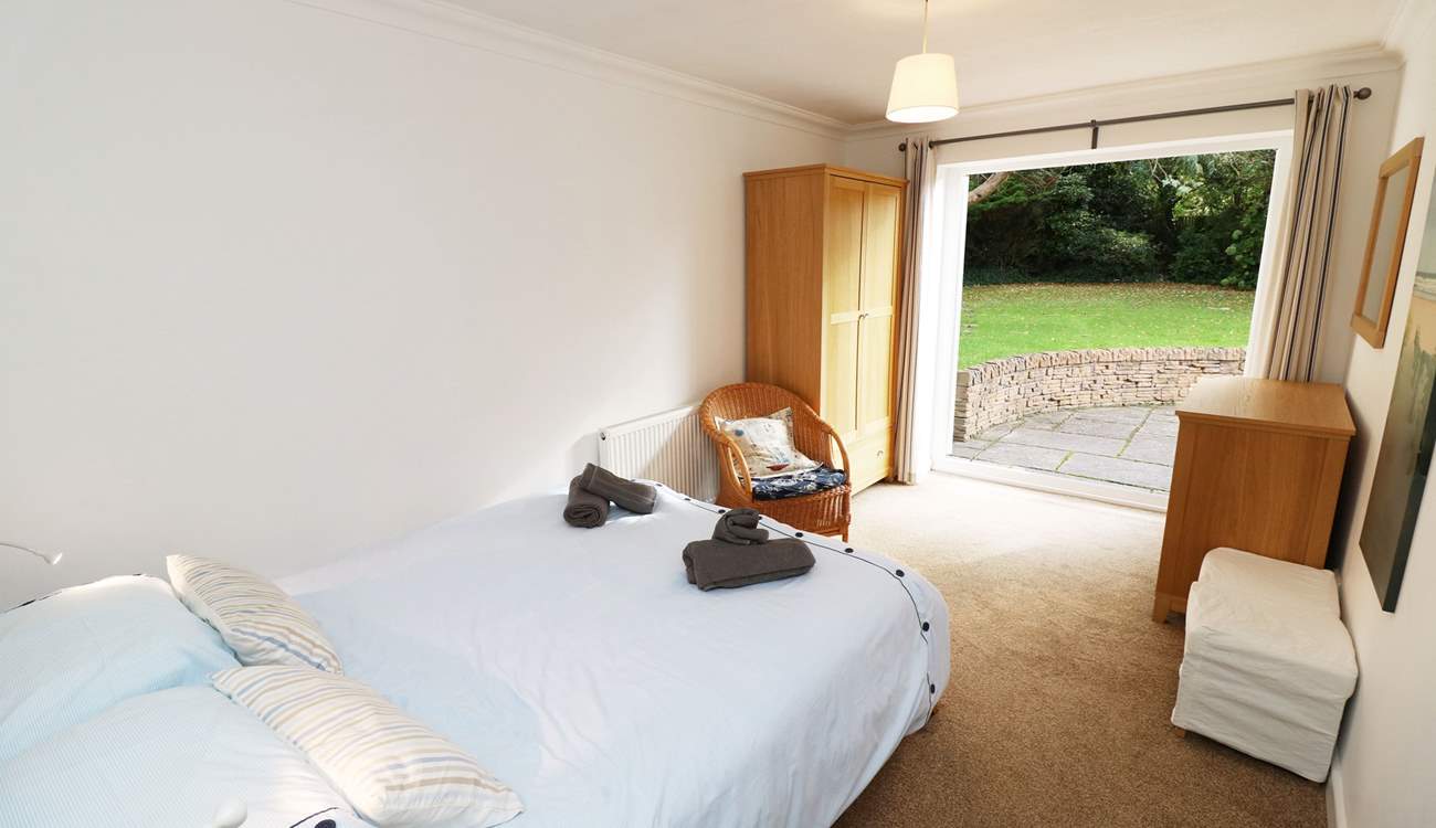 The double bedroom on the ground floor has doors leading out onto the patio.