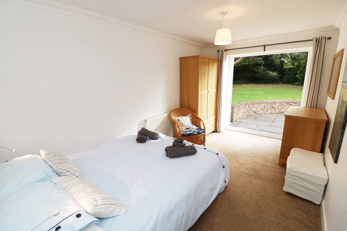 The double bedroom on the ground floor has doors leading out onto the patio.