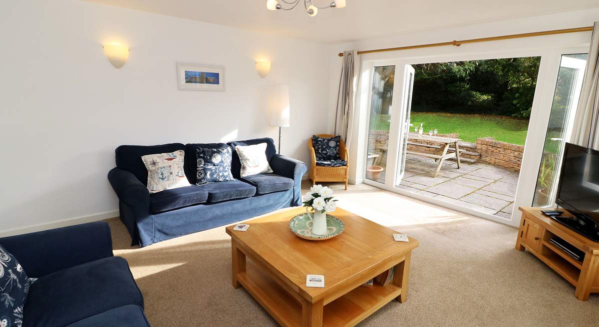 The sitting-room has French doors into the garden. 