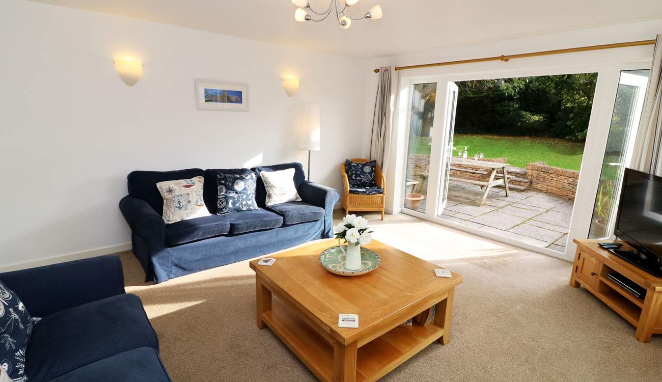 The sitting-room has French doors into the garden. 