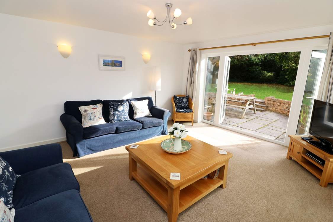 The sitting-room has French doors into the garden.
