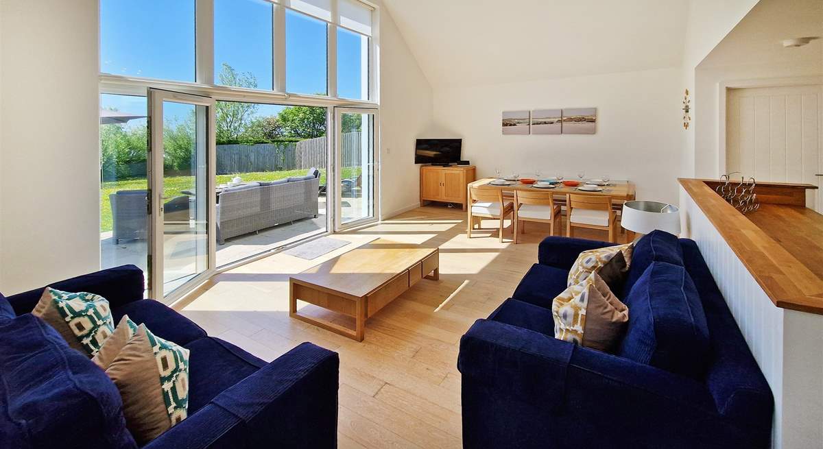 The stylish open plan living space leads out onto the sunny patio. 