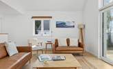 The stylish sitting area offers the best spot for the family to come together and plan the next beach day. - Thumbnail Image