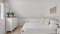 The spacious bedroom - please note the sloping ceiling.