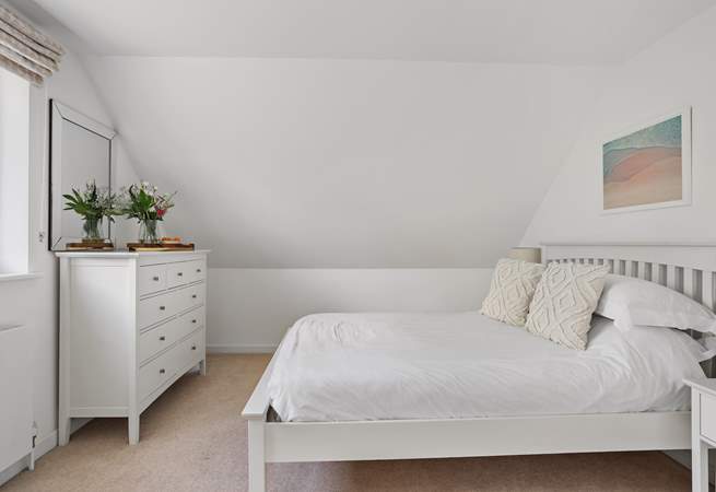 The spacious bedroom - please note the sloping ceiling.