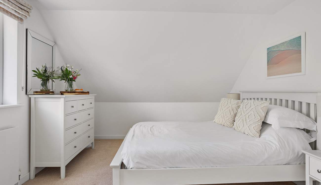 The spacious bedroom - please note the sloping ceiling.