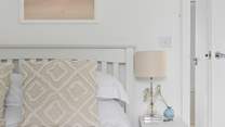 Relax with calming tones and lovely linens.