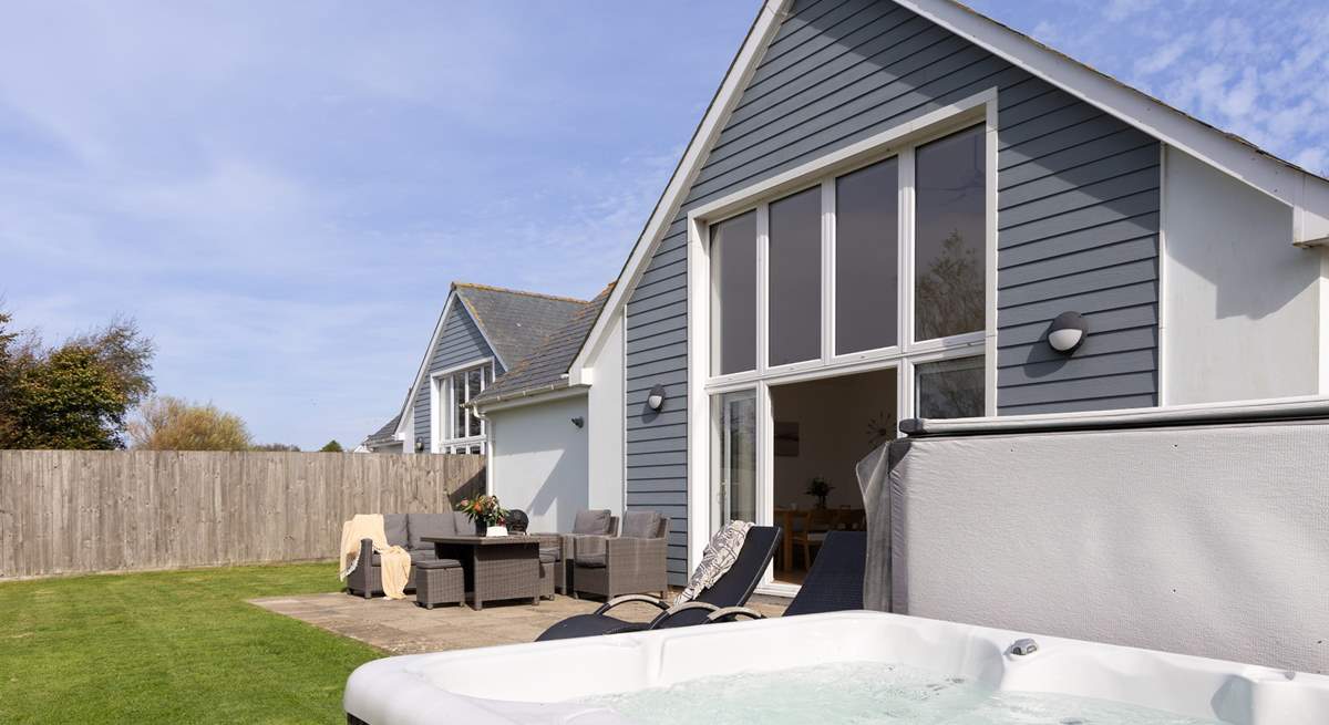 Head back outside to the large back garden with that all important hot tub.