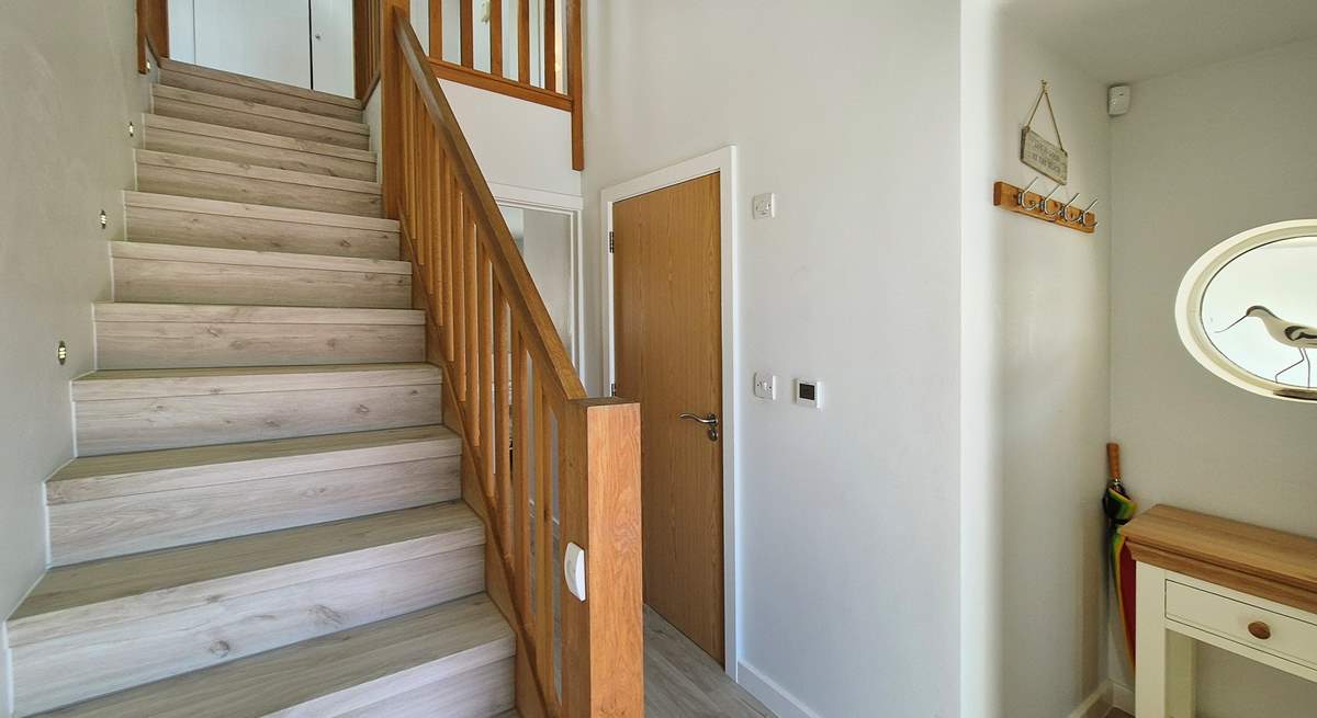 Stairs lead to the first floor with three bedrooms and the family bathroom. 