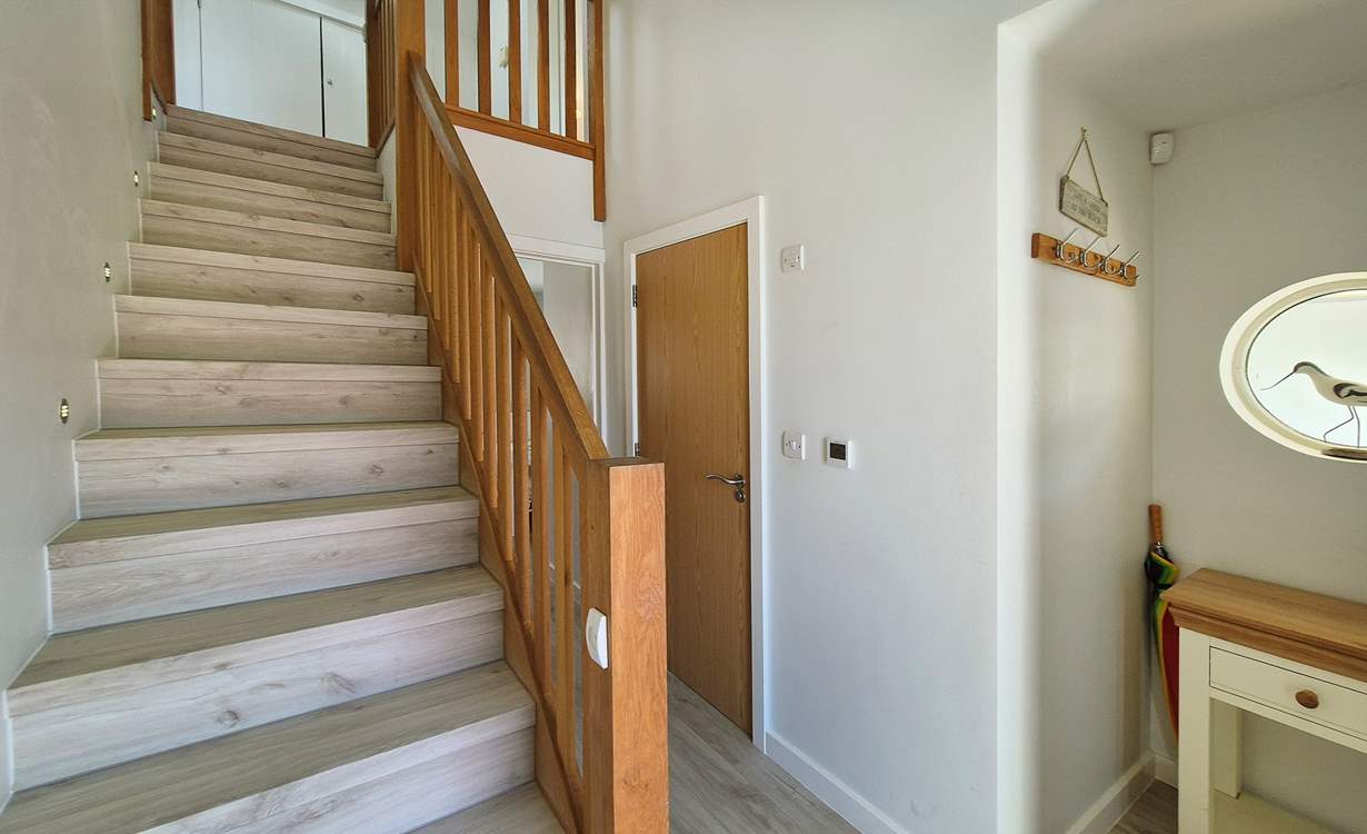 Stairs lead to the first floor with three bedrooms and the family bathroom.