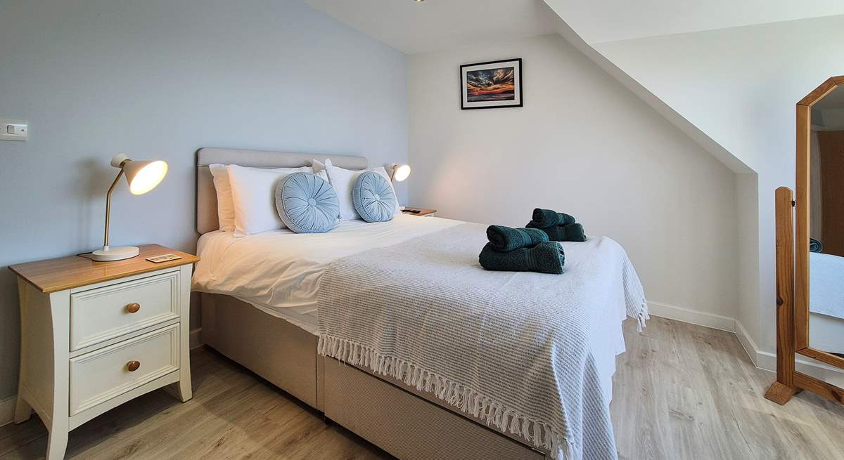 This bedroom is decorated in relaxing neutral shades. 