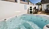 A dip in the hot tub is the ideal way to relax after a beach day. Additional charges apply for the hot tub. - Thumbnail Image