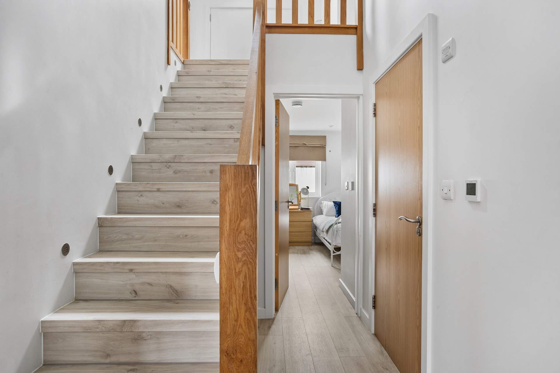 Stairs lead to the first floor with three bedrooms and the family bathroom. 