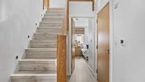 Stairs lead to the first floor with three bedrooms and the family bathroom. 