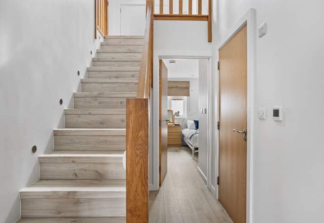 Stairs lead to the first floor with three bedrooms and the family bathroom. 