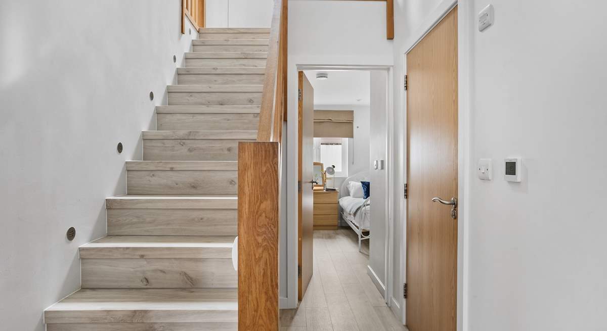 Stairs lead to the first floor with three bedrooms and the family bathroom. 