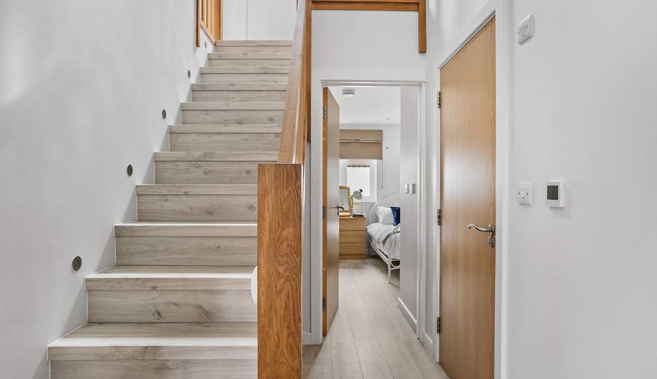 Stairs lead to the first floor with three bedrooms and the family bathroom. 