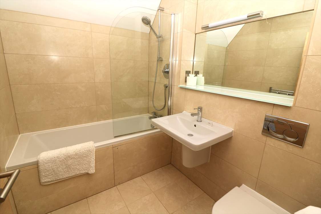 The family bathroom on the first floor has a bath with shower over.