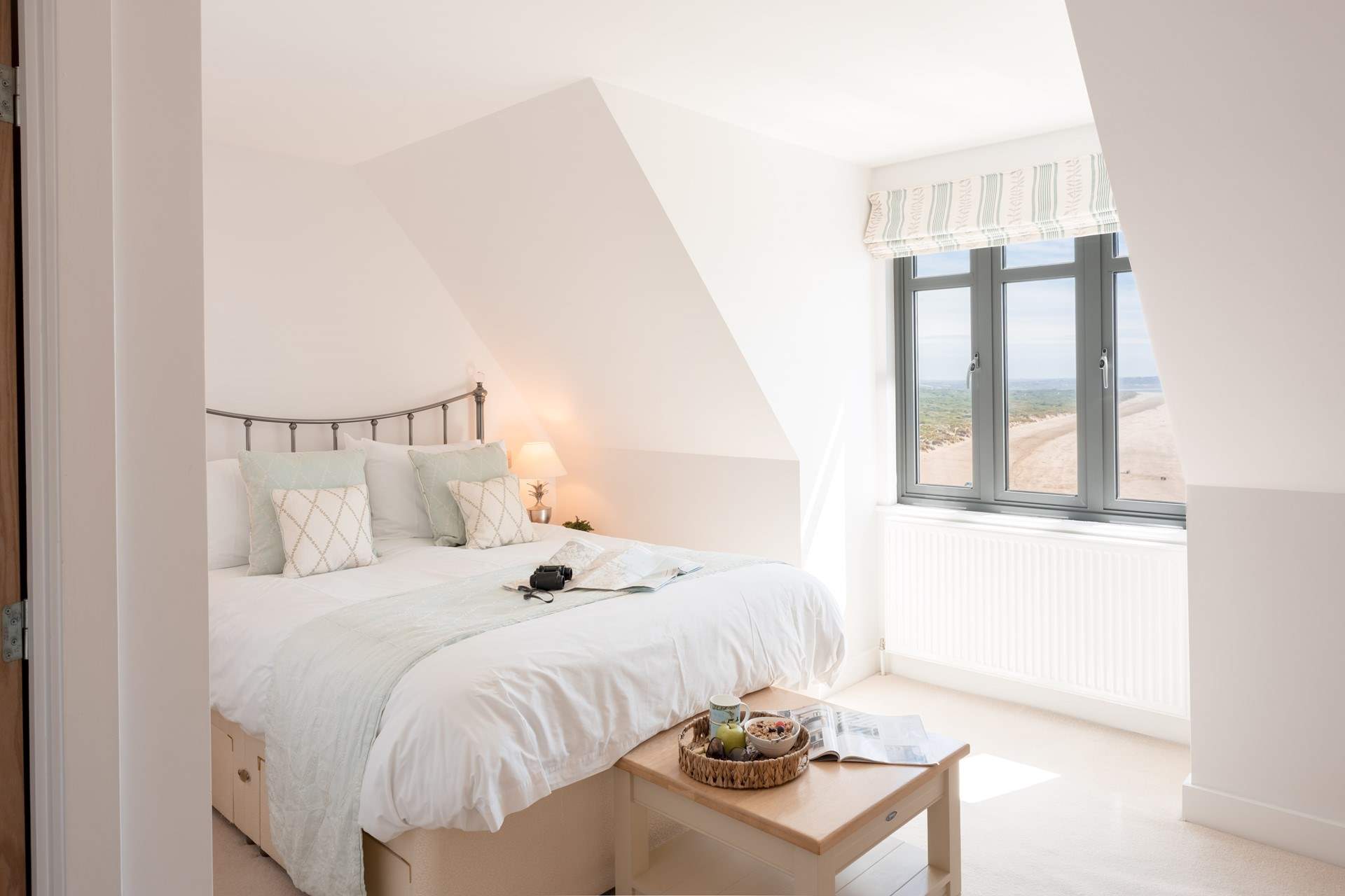 This is bedroom 1 with a king-size bed, an en suite shower-room and stunning views. 