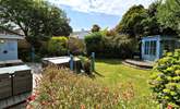 The tranquil garden is surrounded by trees and mature shrubs. - Thumbnail Image