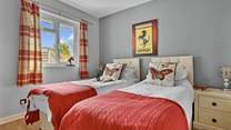 The twin bedroom can also be configured as a king-size bed for flexibility.