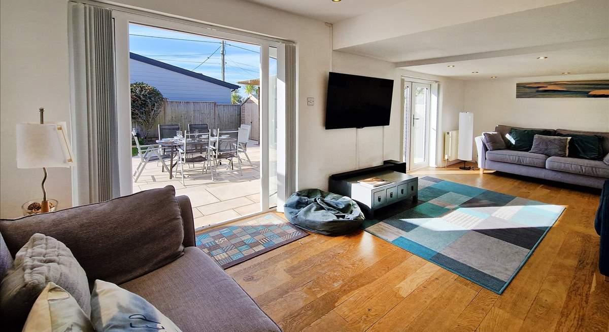 The spacious sitting-room has patio doors leading to the terrace. 
