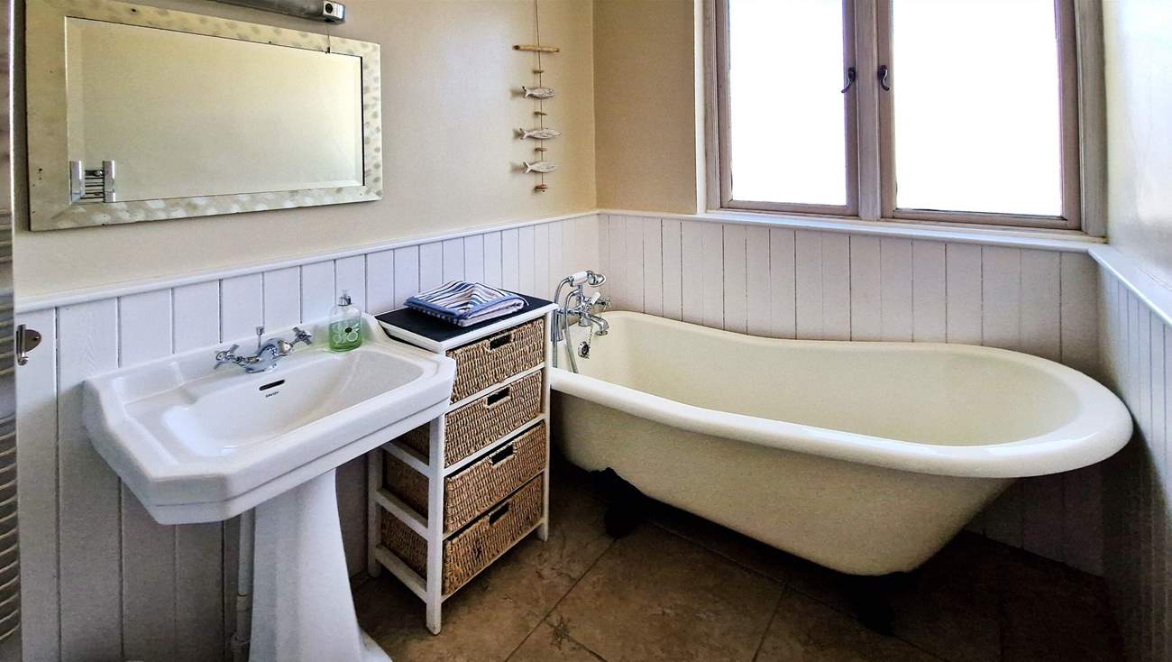 The family bathroom has a bath with hand-held shower.