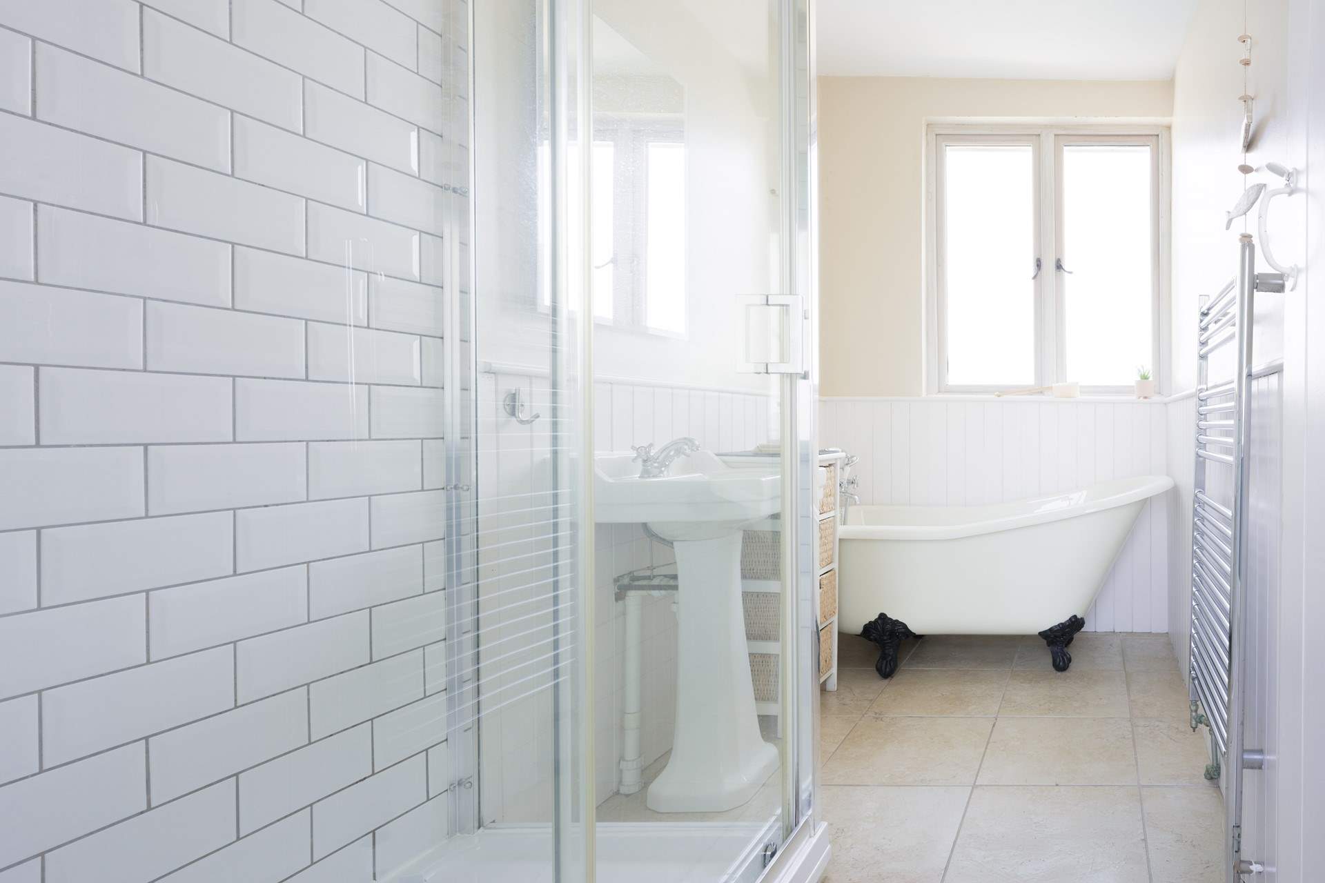 The gorgeous family bathroom with a roll top bath and sink.,