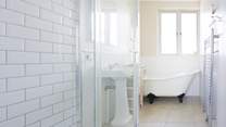 The gorgeous family bathroom with a roll top bath and sink.,