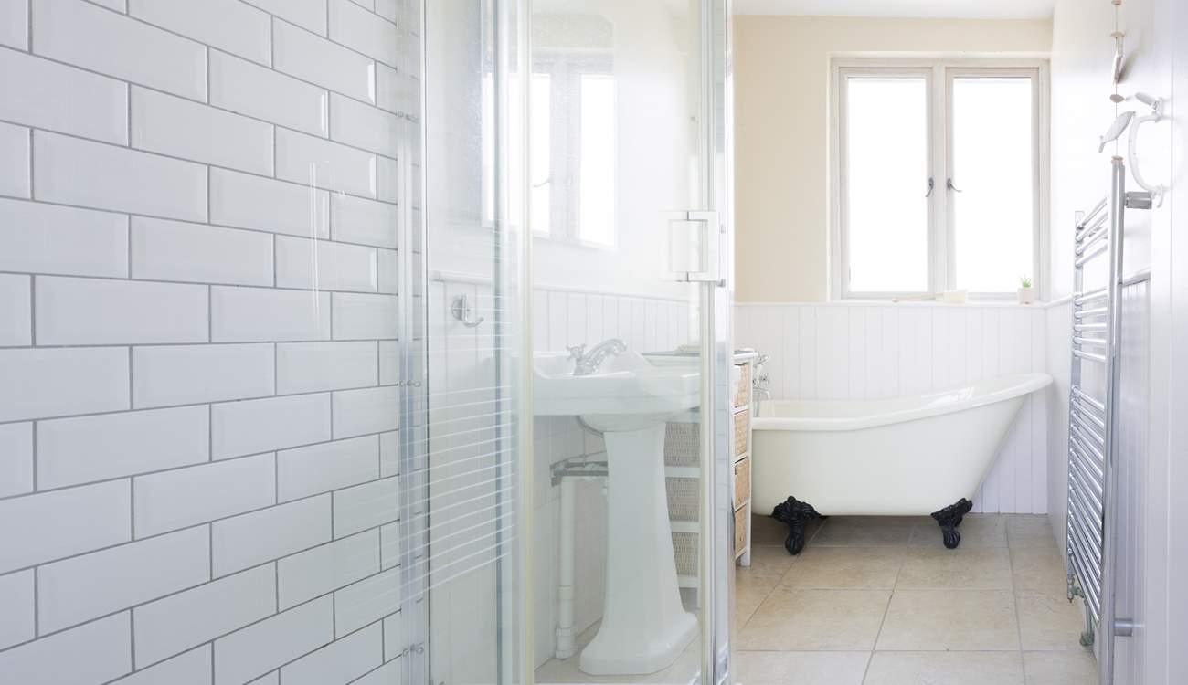 The gorgeous family bathroom with a roll top bath and sink.,