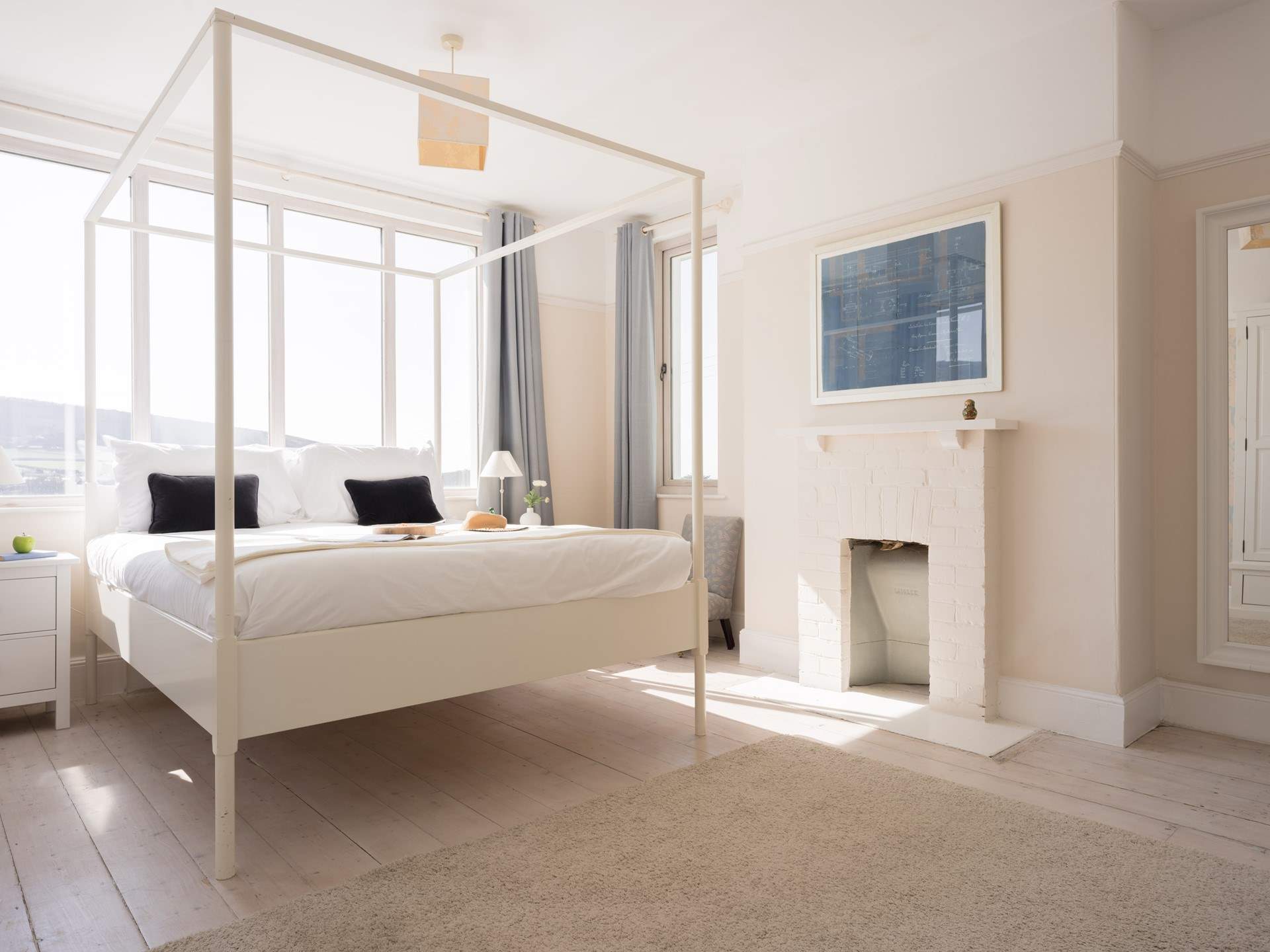 Muted tones and beautiful views all in one bedroom.