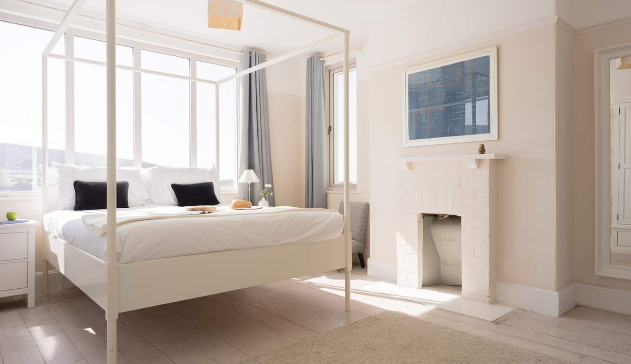 Muted tones and beautiful views all in one bedroom.