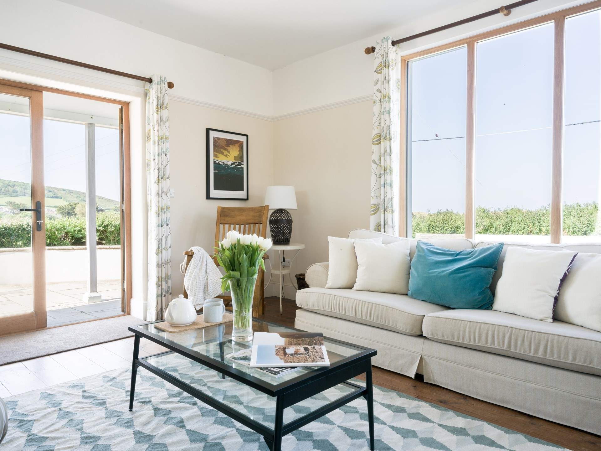 The sitting room has two sofa's a log burner and patio doors that open up on to a stunning view.