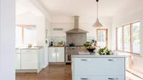The kitchen is fully equipped and floods with light.