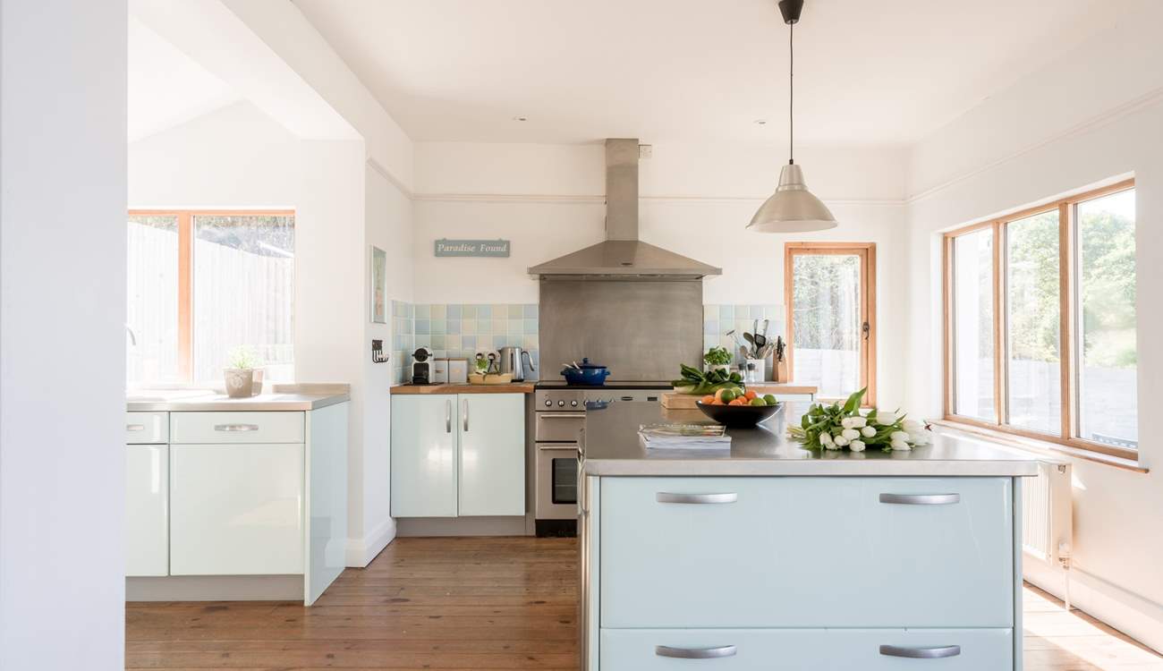 The kitchen is fully equipped and floods with light.