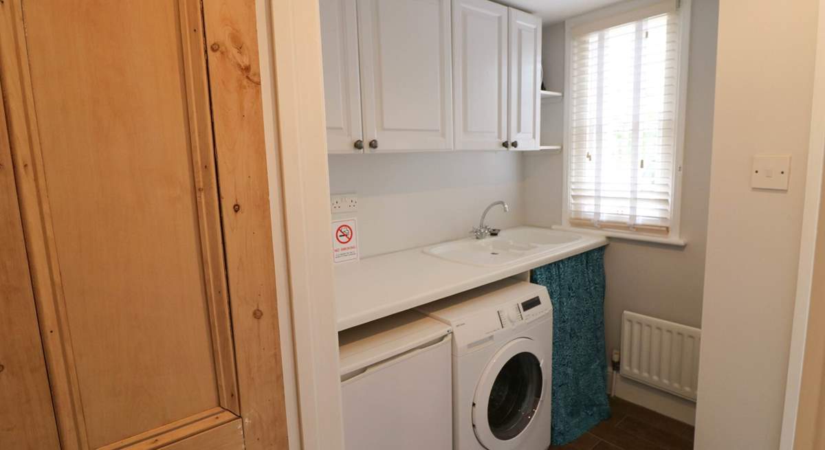 The utility-room has a washing machine and tumble-drier. 