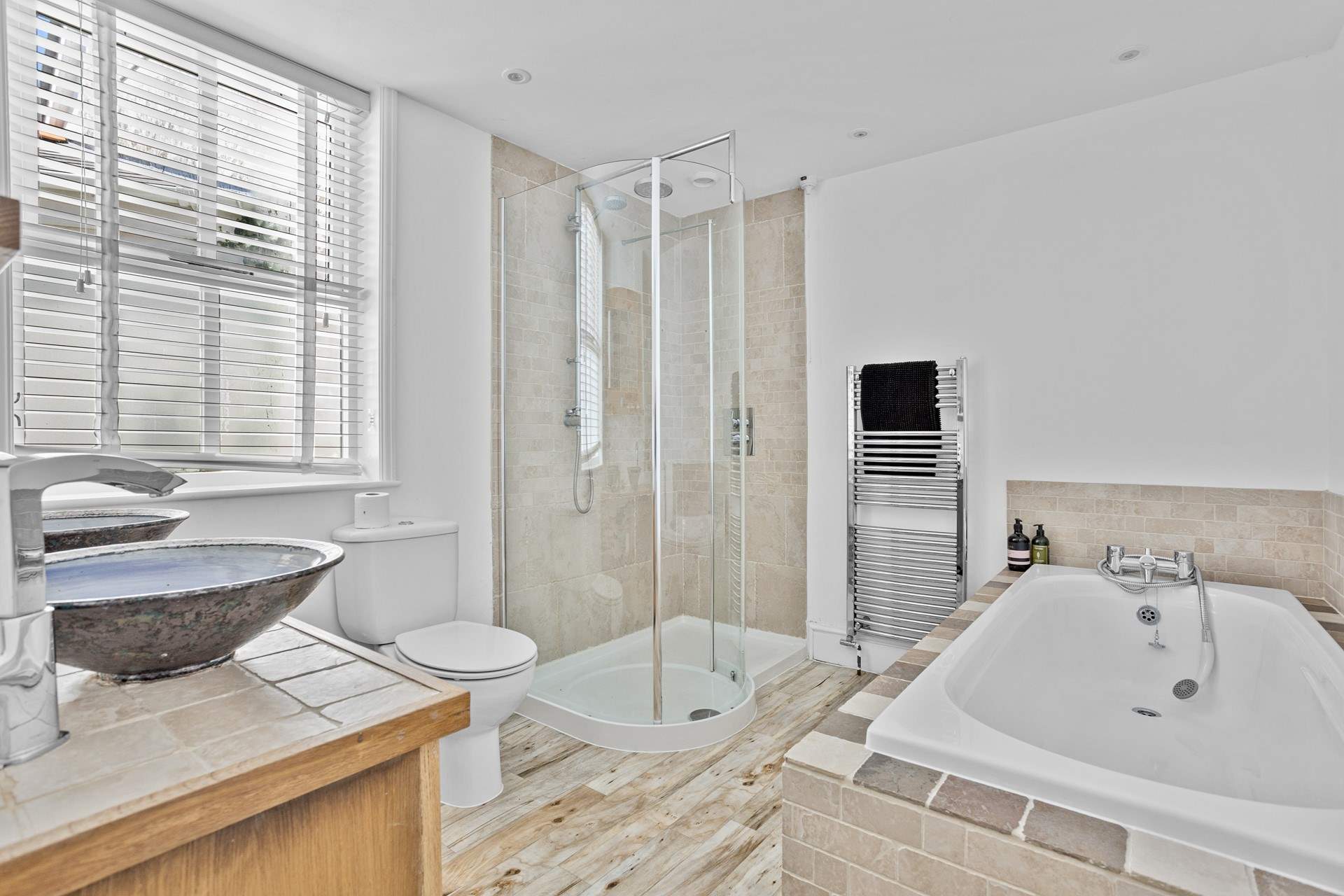 The spacious family bathroom has a bath and shower cubicle. 