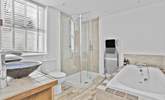The spacious family bathroom has a bath and shower cubicle.  - Thumbnail Image