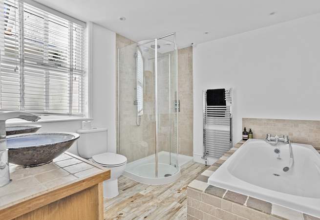 The spacious family bathroom has a bath and shower cubicle. 