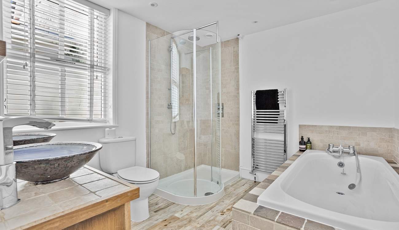 The spacious family bathroom has a bath and shower cubicle. 