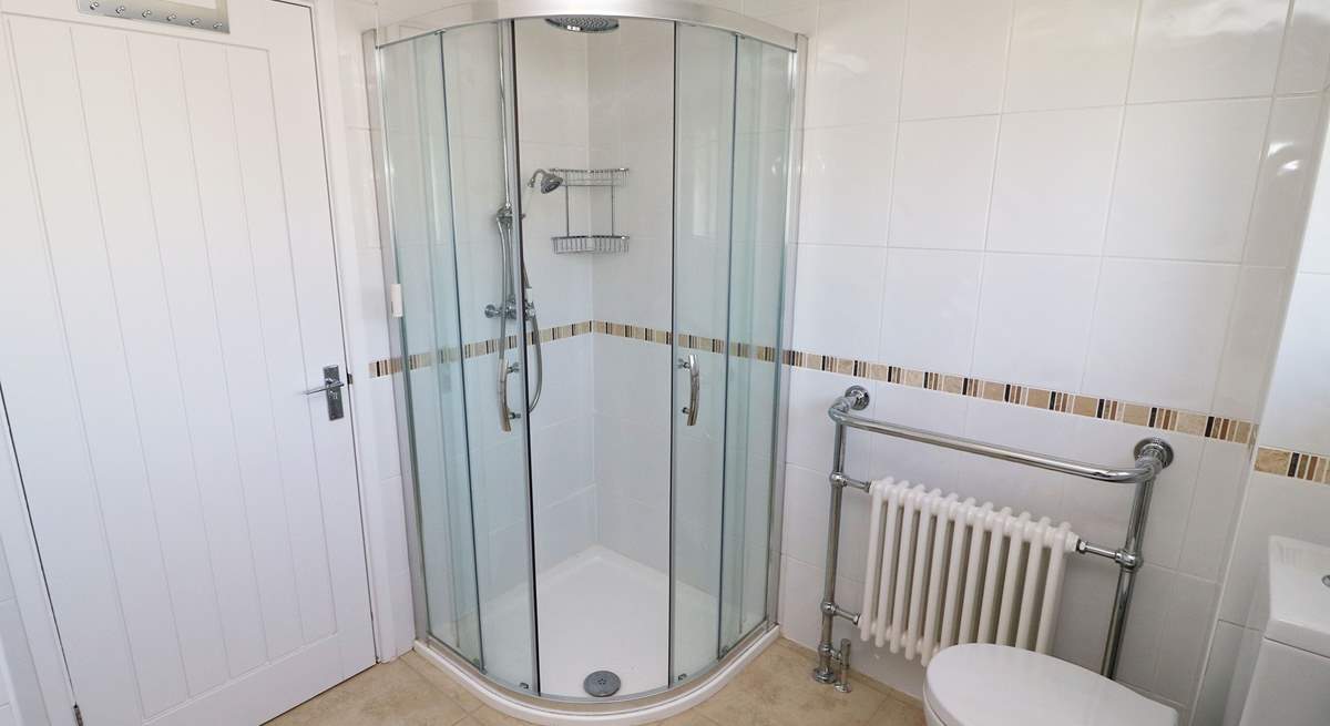 The family bathroom has a free-standing bath and a shower cubicle. 