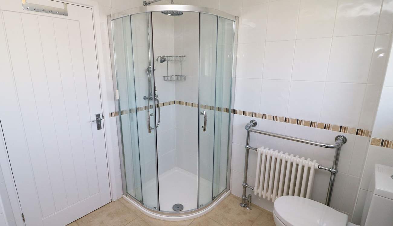 The family bathroom has a free-standing bath and a shower cubicle. 