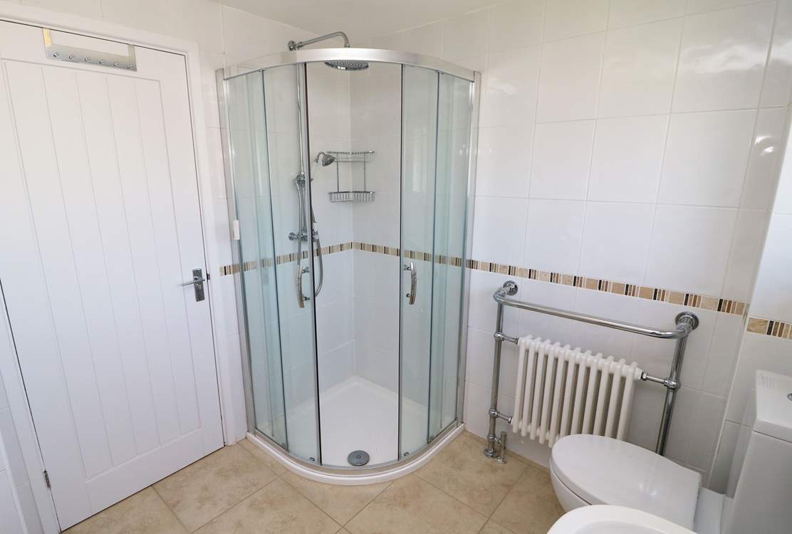 The family bathroom has a free-standing bath and a shower cubicle.