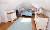 The pretty principal bedroom is on the first floor.  - Thumbnail Image