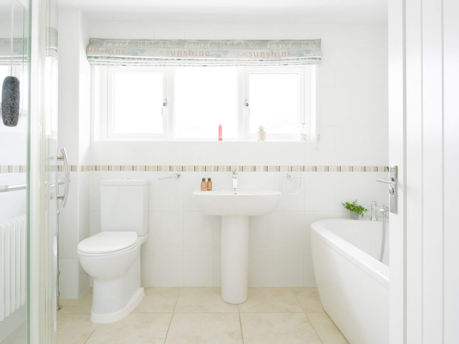 The ground floor family bathroom with roll top bath and a shower cubicle.